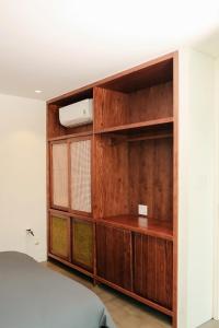 a bedroom with a wooden book shelf and a bed at PHAM. Hotel & Views in Hai Phong +39 photos