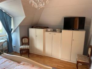 a bedroom with white cabinets and a flat screen tv at Bergblick Apartment in Lienz