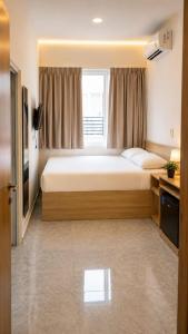 a bedroom with a large bed and a window at Merryland ICE BSD City in Tjilandak