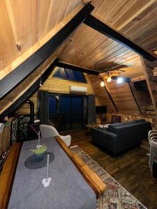 a living room with a couch and a table at Himora Suit Bungalov in Ardeşen