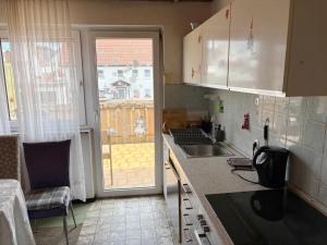 a small kitchen with a sink and a window at Monteurhaus in Giengen an der Brenz-Burgberg in Giengen an der Brenz