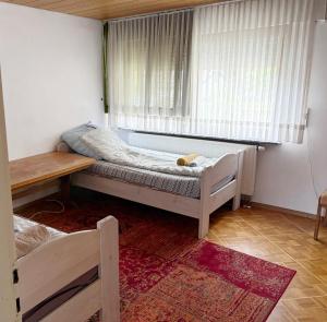 a small bedroom with a bed and a window at Monteurhaus in Giengen an der Brenz-Burgberg in Giengen an der Brenz