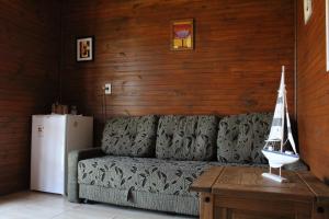 a living room with a couch and a table at Green Mountain Pousada in Florianópolis