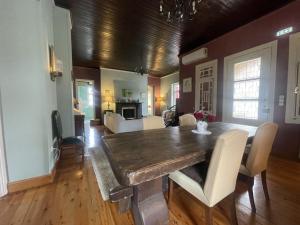 a dining room with a table and a living room at Villa Enoteca - Wine Experiences in Neméa