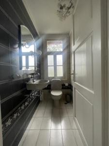 a bathroom with a toilet and a sink and a window at Villa Enoteca - Wine Experiences in Neméa +25 photos