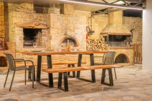 a table and chairs in front of a stone oven at Dafni Villa a place to visit by Rentado in Orné