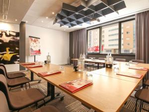 a conference room with a large wooden table and chairs at Ibis Sfax in Sfax +251 photos