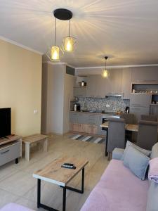 a living room with a couch and a table at Sea View Marjana Apartment in Skataj