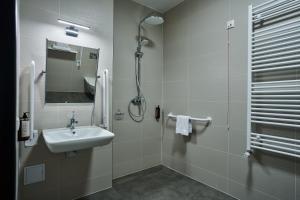 a bathroom with a sink and a shower at Hotel Nowa Bukowa in Katowice