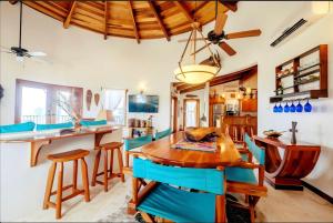 a dining room with a wooden table and chairs at Indigo Belize Beach 2C in San Pedro
