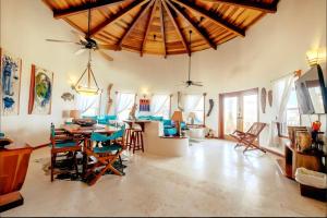 a large living room with a wooden ceiling at Indigo Belize Beach 2C in San Pedro +8 photos