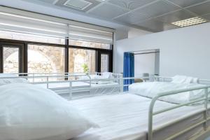 a bedroom with two beds and a window at New Gate Hostel in Jerusalem +52 photos