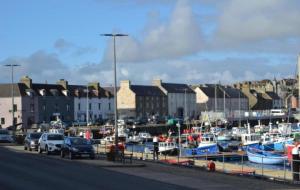 a group of boats parked in a harbor at Wick Harbour View Apartment - 2 Beds - Sleeps 3 - Ideal for Couples in Wick
