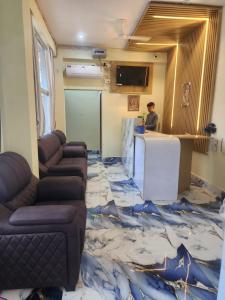 a room with a table and couches in a room with a floor covered in at Hotel Navin Palace Pirpainti in Bhāgalpur