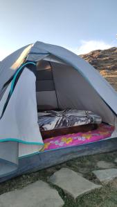 a tent sitting on the ground in a field at Raghupur trecking camp in Shoja