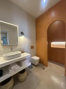 a bathroom with a sink and a toilet and a mirror at Apocalypsis Houses in Skala +120 photos