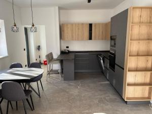 a kitchen and dining room with a table and chairs at Casa Vian in Vigo di Fassa