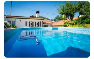 a swimming pool in front of a house at Casa de Alvite in Alvito
