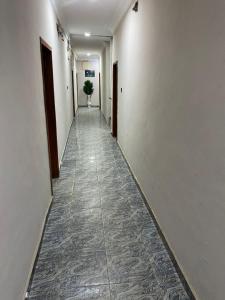 a long hallway with a plant in the middle of it at MerryJay Hotels in Otta