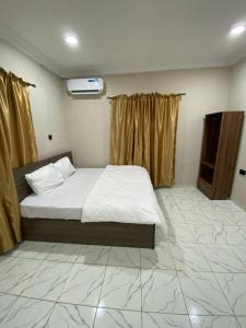 a bedroom with a bed and a television in it at MerryJay Hotels in Otta