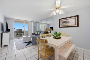 a living room with a table and a couch at Perdido Sun 1008 in Perdido Key