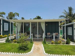 a house with glass doors and a patio at Green House 168 in Kaôh Rŭng (3)