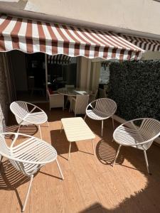 a group of chairs and tables on a patio at Hotel Le Fouquet's in Cannes