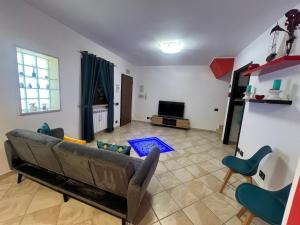a living room with a couch and a television at La Cha di Giada in Anzio