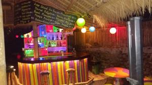a bar in a restaurant with a colorful counter at Topi inn in Padangbai