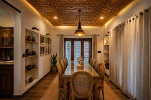 a dining room with a table and chairs at The Riverside Barn Srinagar in Srinagar +9 photos
