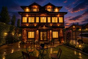 a home with a large building with lights at The Riverside Barn Srinagar in Srinagar