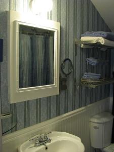 a bathroom with a sink and a mirror and a toilet at Auberge De Mon Petit Chum B&B in Wakefield +57 photos