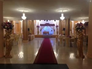 a banquet hall with a red carpet and a altar at Issham Hotel in Jeddah