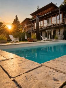 a house with a swimming pool in front of a house at Alpine Sunlight Villa in Villach