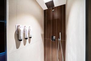 a bathroom with a shower with a control panel on the wall at 천호 호텔 코드 in Seoul +51 photos