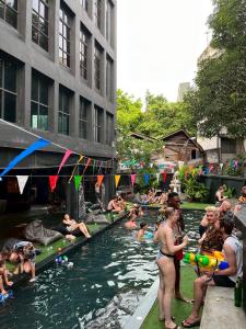a group of people swimming in a river at BED STATION Hostel Khaosan in Bangkok
