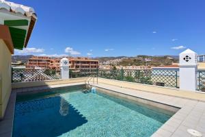 a swimming pool on the roof of a building at Club Oasis Flat in Málaga