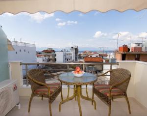 a balcony with a table and chairs and a view at Hotel Viana in Loutra Edipsou