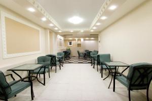 a row of tables and chairs in a waiting room at Hotel Viana in Loutra Edipsou