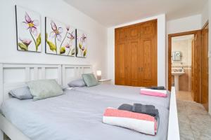 a bedroom with a bed with two towels on it at Club Oasis Flat in Málaga +20 photos
