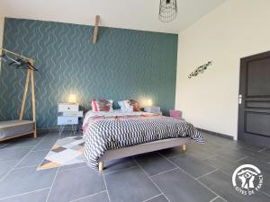 a bedroom with a bed and a green wall at Au brunet in Saint-Élix-Theux
