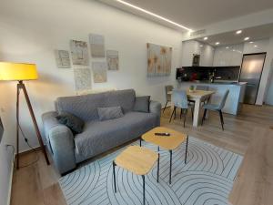 a living room with a couch and a table at Private Garden Apartment - Villamartin, Orihuela Costa in Villamartin