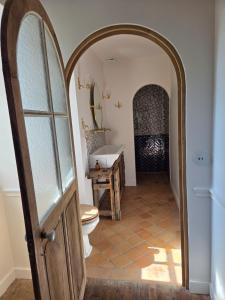 a bathroom with a toilet and a sink at Château de Beaumanoir in Évran