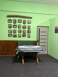 a room with a bench with pictures on the wall at Dom Hostel in Samarkand