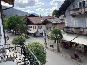 a view from a balcony of a street with buildings at City Apartment in Oberammergau