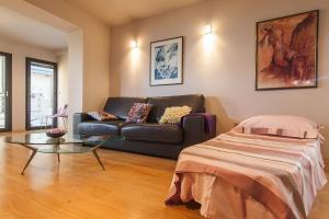 a living room with a couch and a glass table at Apartments Glusac in Podgora