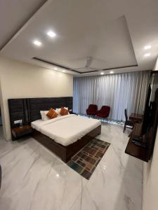 a bedroom with a large bed and a living room at Barog Heights in Barog +7 photos