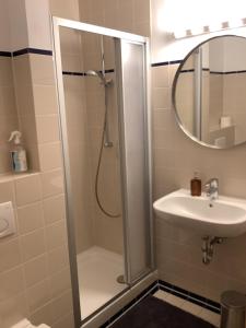 a bathroom with a shower and a sink at City Apartment in Oberammergau