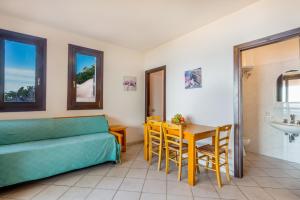 a living room with a couch and a table at Paradiso in Costa Paradiso