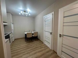 a room with a table and chairs and a door at Central cozy apartments- one and two bedrooms option in Chişinău +4 photos